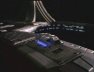 A Danube-class runabout craft wams up its engines on the docking pad prior to departing Deep Space Nine. CLICK TO SEE A LARGER VIEW!